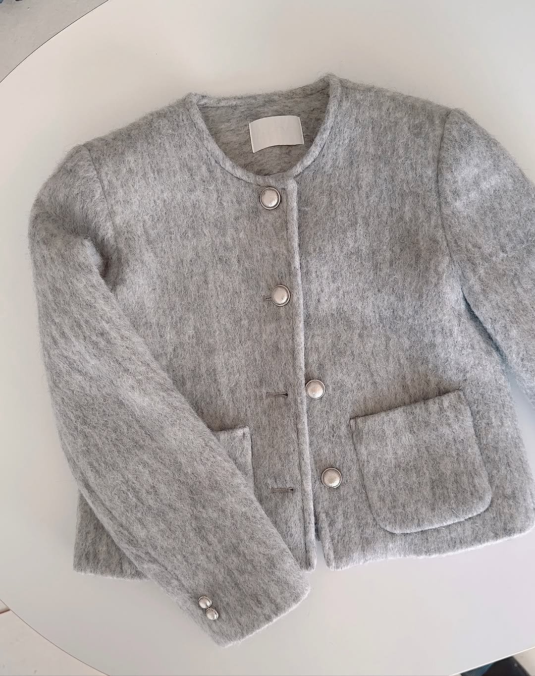 Photo by PECAN 피칸 on November 12, 2025. May be an image of coat, fleece, wool, cardigan, sweater and text.