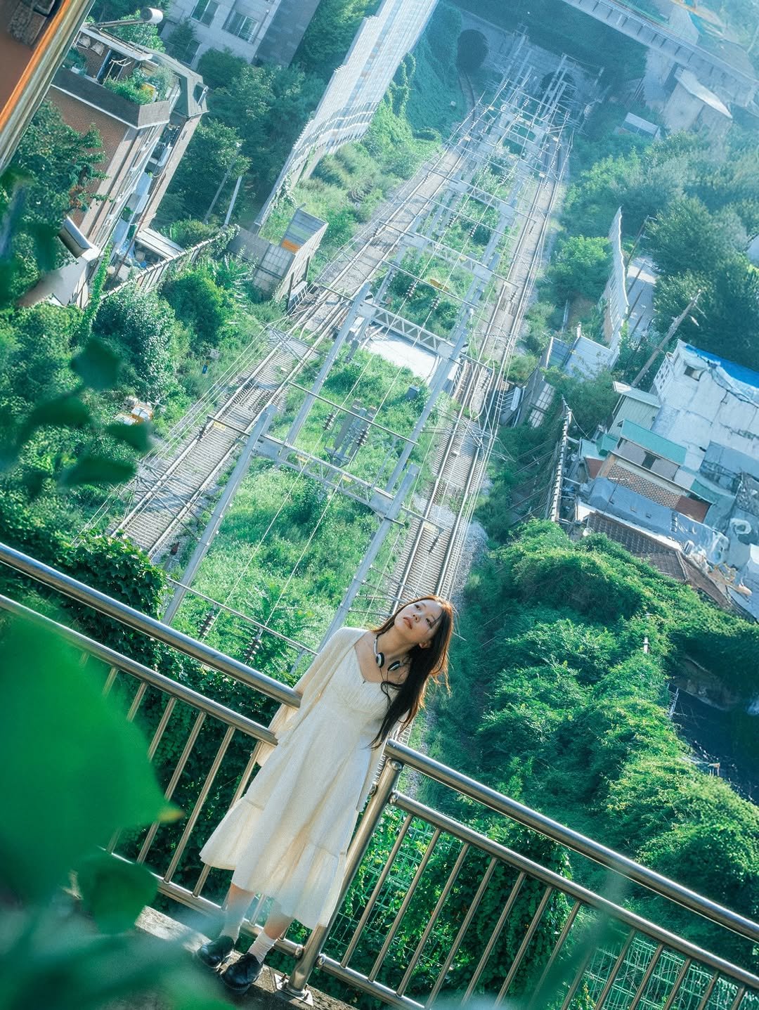 Photo shared by 이선우 on August 12, 2025 tagging @xeozxi. May be an image of 1 person, Victoria Peak, skyscraper, suspension bridge and text.