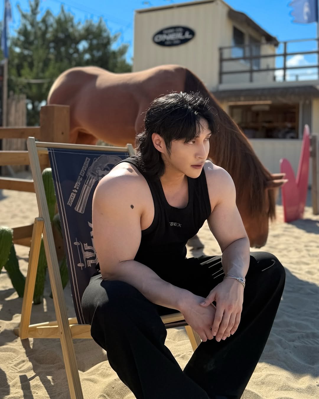 Photo shared by 조준 (Jun Cho) on July 29, 2025 tagging @hdex__official. May be an image of 1 person, biceps, outdoors and text.