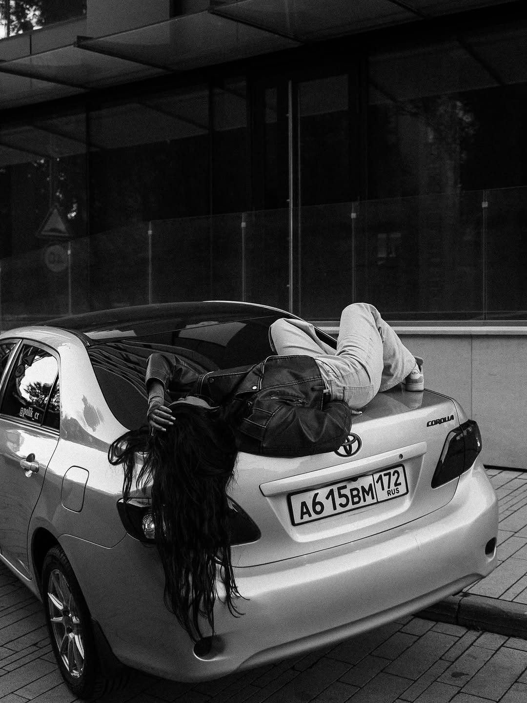 Photo shared by ПОЛИК on September 25, 2025 tagging @hawallkin_. May be a black-and-white image of one or more people, people sleeping, tire, cigarette, bus, street, curb and text that says 'COROLA A615BM/172 RUS'.