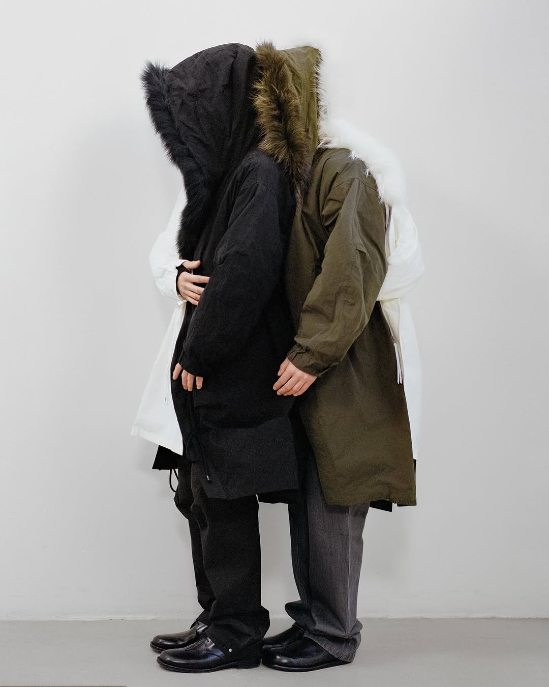 Photo by POST ARCHIVE FACTION (PAF) on November 28, 2025. May be an image of duffle coat, overcoat, goosedown coat, fur coat, snowsuit, face mask, raincoat, parka, cloak and text.