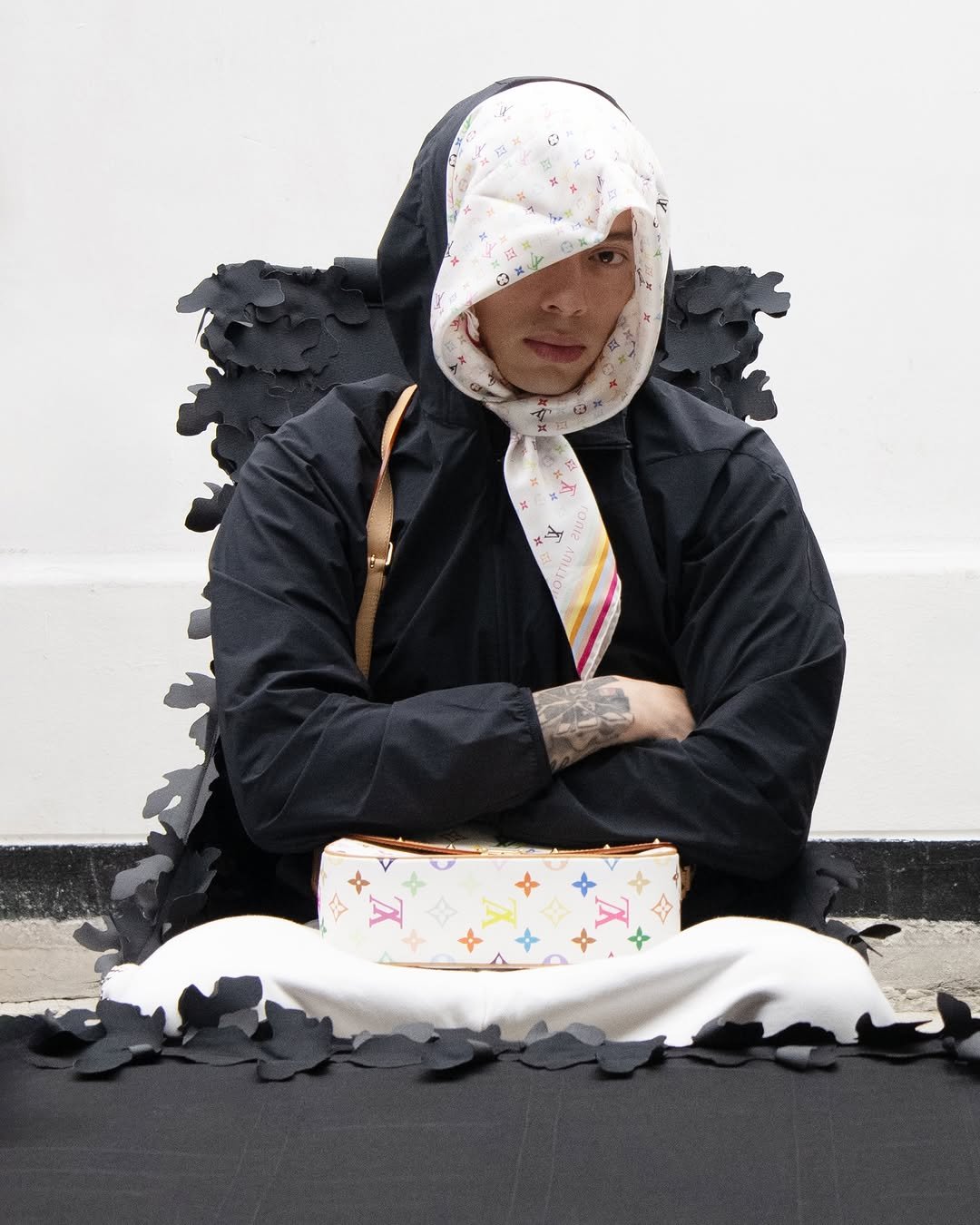 Photo shared by POST ARCHIVE FACTION (PAF) on March 15, 2026 tagging @livebase, and @synaworld. May be an image of face mask, plastic bag, headscarf and text.