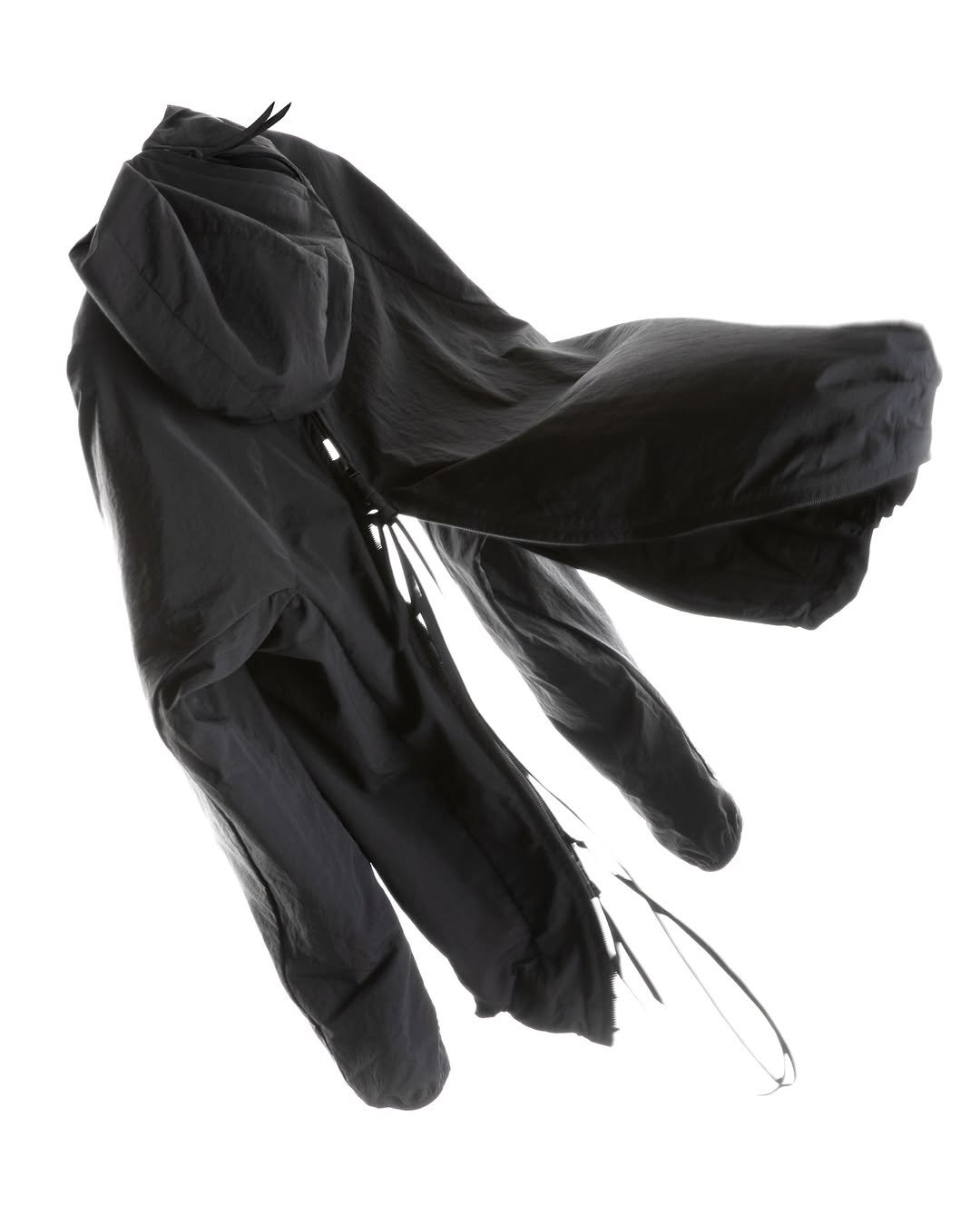 Photo by POST ARCHIVE FACTION (PAF) on February 20, 2026. May be an image of raincoat, parka, umbrella, face mask and text.