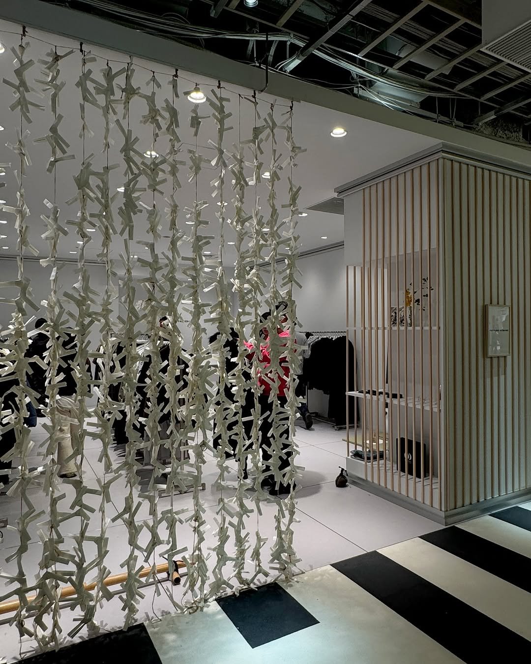 Photo by POST ARCHIVE FACTION (PAF) on December 12, 2025. May be an image of lighting, display case, chandelier, curtains, indoors, sliding door, hallway and text.