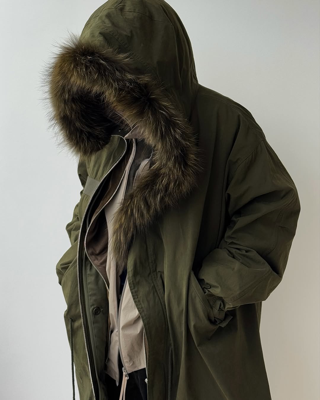 Photo by POST ARCHIVE FACTION (PAF) on October 23, 2025. May be an image of overcoat, duffle coat, sable coat, goosedown coat, raincoat, cloak, parka, flight jacket and text.