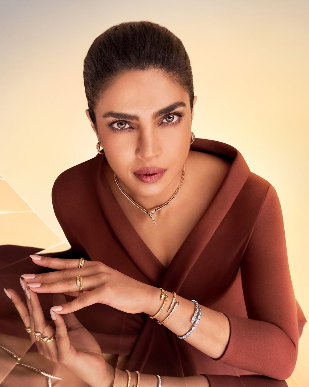 Photo shared by Priyanka on January 10, 2026 tagging @bvlgari. May be an image of one or more people, makeup, jewelry, bangle and text.