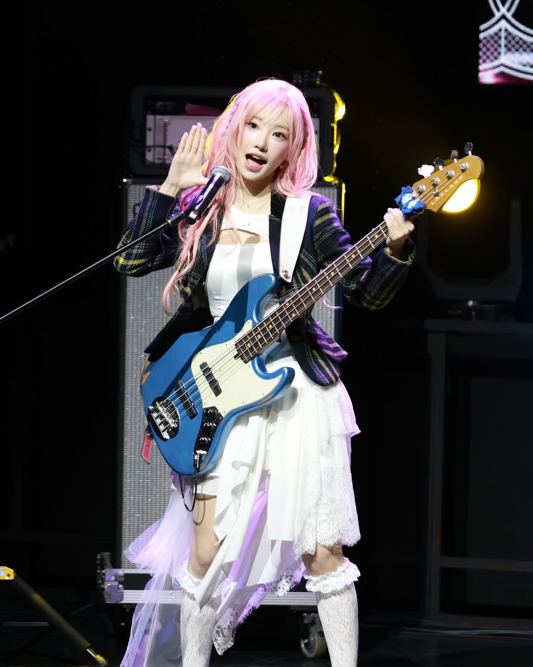 Photo by QWER on April 27, 2026. May be an image of guitar, concert and text.