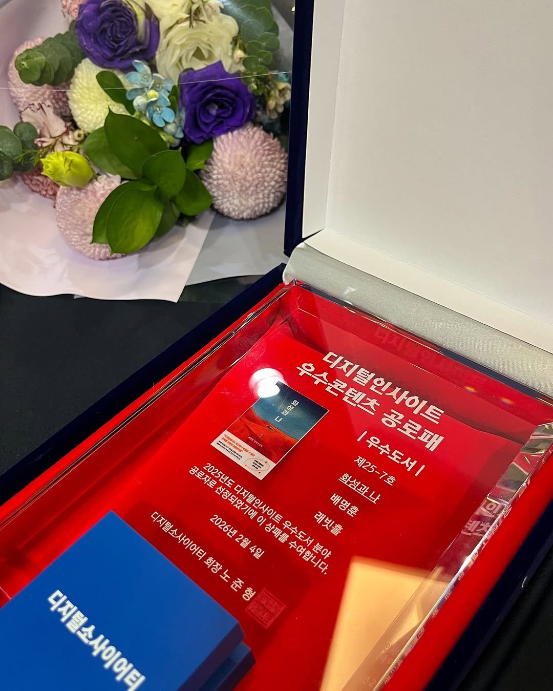 Photo by 인플루엔셜 문학 브랜드 래빗홀 on February 04, 2026. May be an image of flower arrangement, hamper, bouquet, baby's-breath, prairie gentian, rose and text that says '配安球 우수콘텐츠 디지털인사이트 4 ေ PN 2025년도 디지털인사이트우수도서분야 4일 제25 공로자로 지로선정돼있기예이상패를수여합니다. 디지털소사이어터화장노준형 디지털소 디지털소사이어 2026년 2026년2월4일 선정되었기예 디지털인사이트 배명훈 愛 화성과나 제25-7호 우수도서| 공로패 상패를 우수도서 래빗홀 2월4일 회장 회장노준 수여합니다. 분야 디지털소사이어티 C4Aagra ម្េ 형 o'.