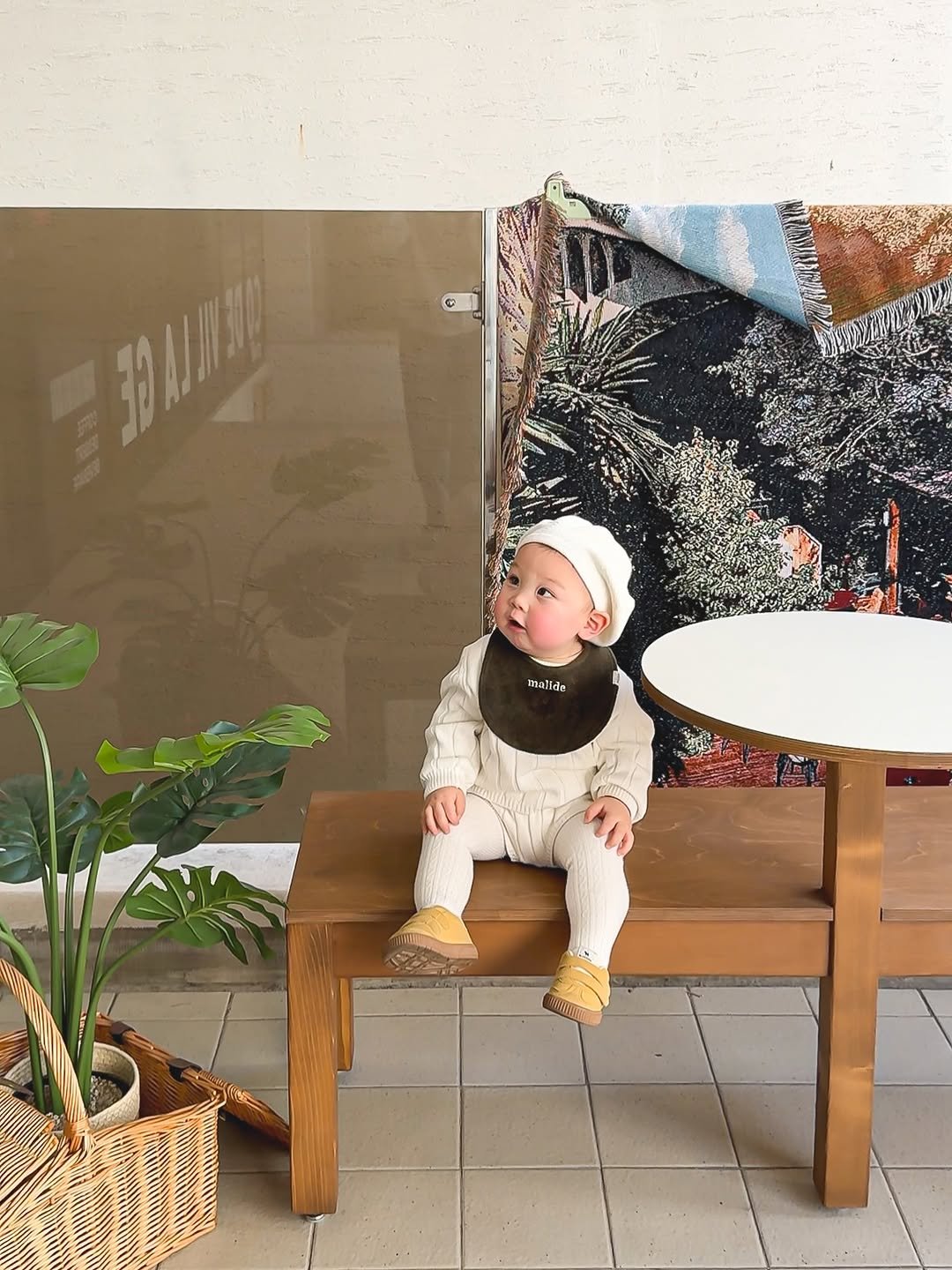 Photo shared by 1일1도하🖤 on February 23, 2026 tagging @theloha.kr, @ramiii_eo, and @codevillage_coffee. May be an image of baby, standing, duffle coat, headscarf, beret, cornflower and text.