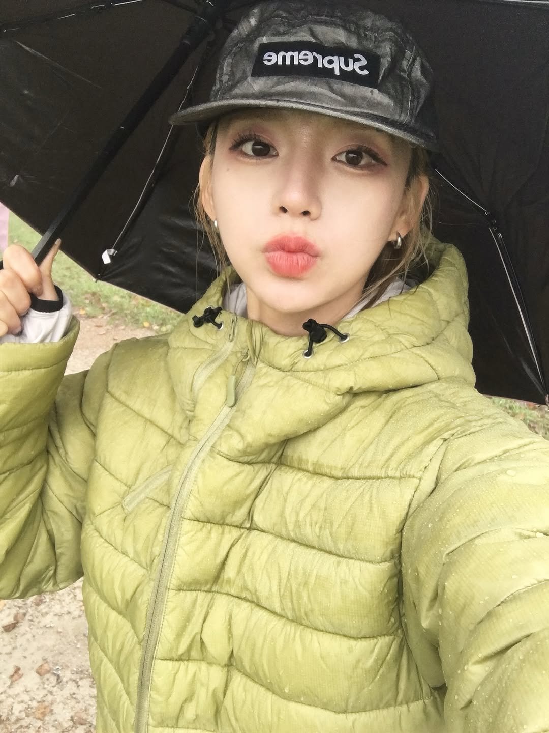 Photo by 안아란 on October 23, 2025. May be an image of duffle coat, goosedown coat, hat, raincoat, parka, umbrella, outdoors and text.