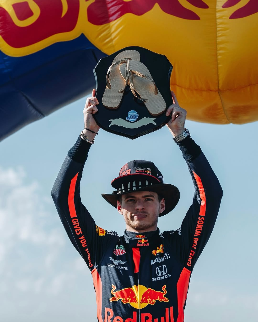 Photo shared by Oracle Red Bull Racing on March 01, 2026 tagging @maxverstappen1. May be an image of racing vehicles, parachute, helmet and text.