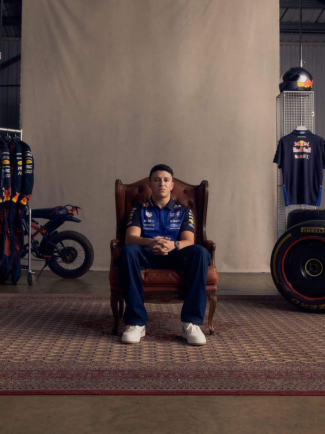 Photo shared by Oracle Red Bull Racing on January 17, 2026 tagging @castore_sportswear, @isackhadjar, and @redbullshop. May be an image of racing vehicles, helmet, rocking chair and text.