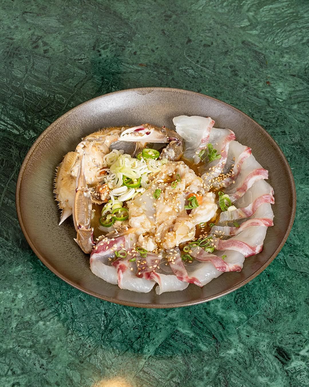 Photo by 남준영 on September 24, 2025. May be an image of octopus, sashimi, sushi and text.