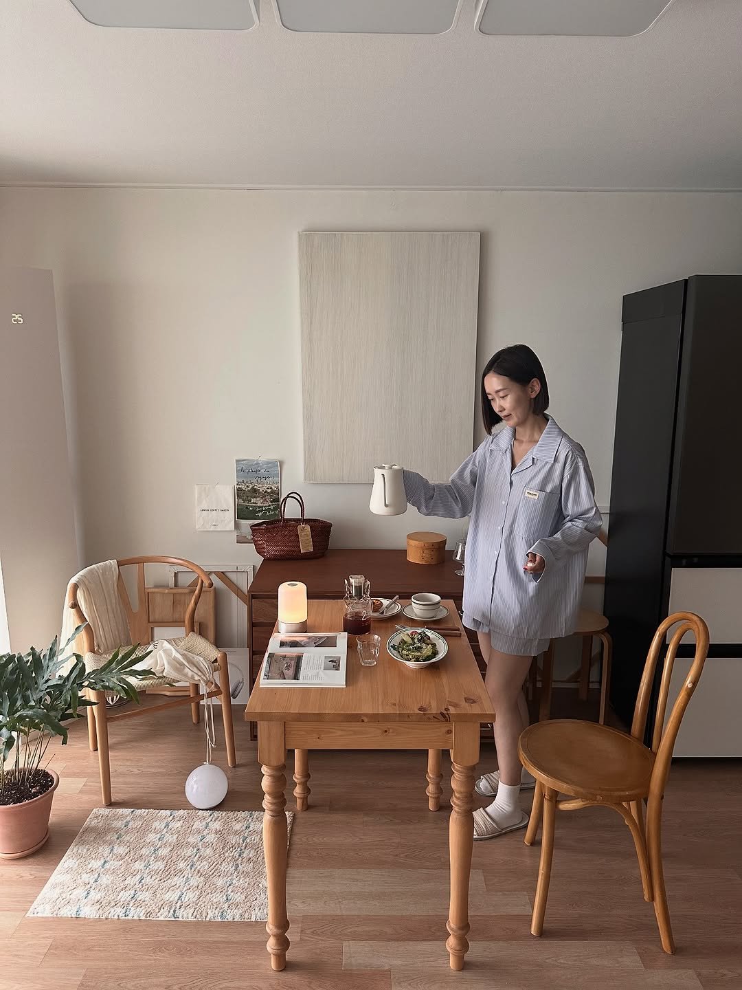 Photo shared by 른 른 ♡ on September 19, 2025 tagging @opengallery.co.kr. May be an image of 1 person, sleepwear, house plant, bath robe, cornflower, indoors and text.