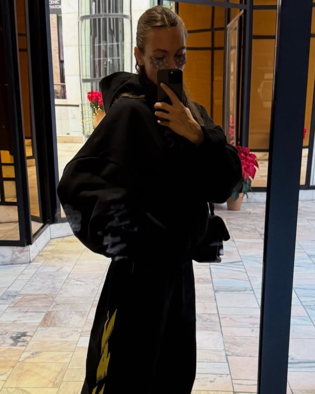 Photo shared by rhode skin on January 12, 2026 tagging @venedaacarter. May be an image of duffle coat, overcoat, raincoat, sweatpants, robe, bath robe, cloak, sweatsuit, parka and text.