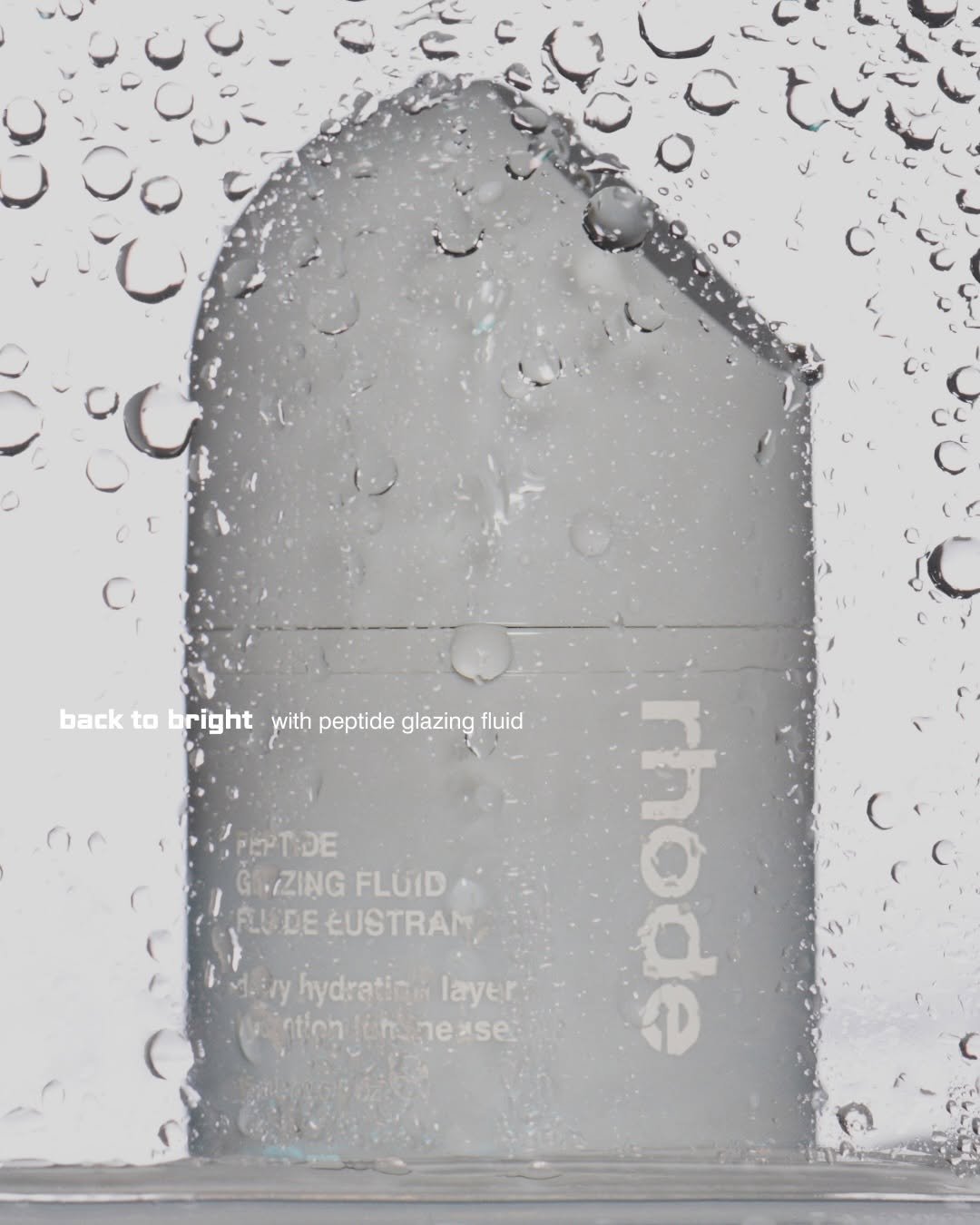 Photo by rhode skin on January 09, 2026. May be an image of hair product, fragrance, cosmetics, lotion, hand cream, perfume and text that says 'U back to bright with peptide glazing fluid PEPTIDE GAZING FLUID LUDE EUSTRAM diiry hydratin. layer ation ennease Hin ease rhode'.