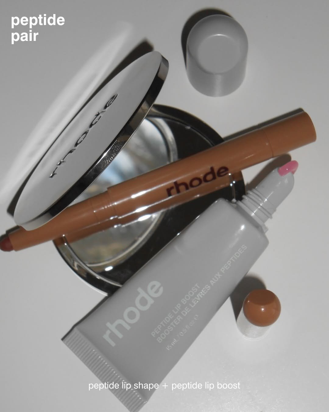 Photo by rhode skin on February 28, 2026. May be an image of one or more people, makeup, lipstick, cosmetics, hand cream and text that says 'peptide pair VIE ០ rhode O LIP DE AUX UXPEPTIDES PEPTIDES BOOST LEVRES BOOSTER 15ml peptide lip. shape pepidelipshape+pepideipboost + peptide lip boost'.