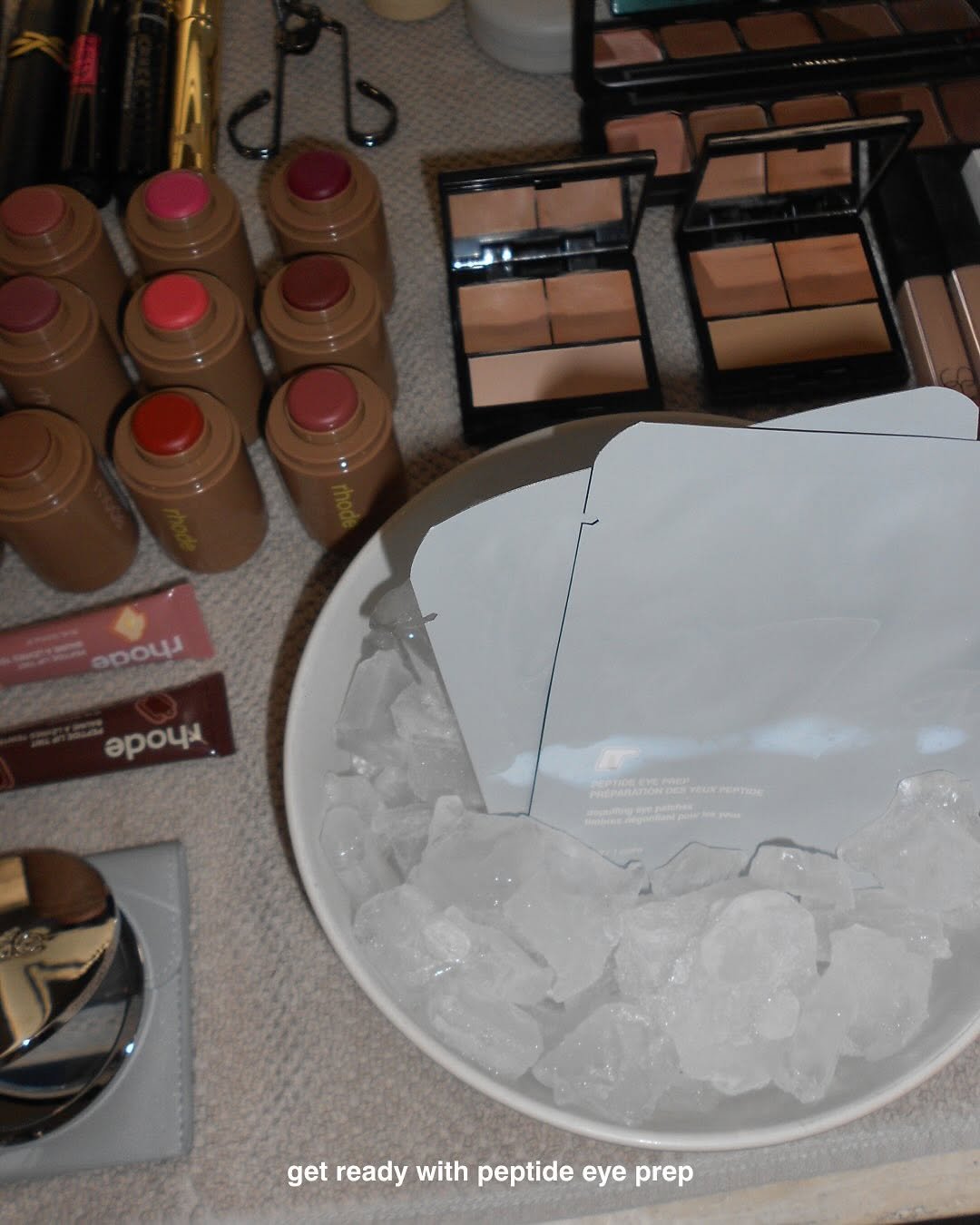 Photo by rhode skin on October 12, 2025. May be an image of one or more people, makeup, lipstick, pallette, brush, cosmetics and text that says 'opouR 00 epouи ia getreadywithpeptideeyepre get ready with peptide eye prep'.