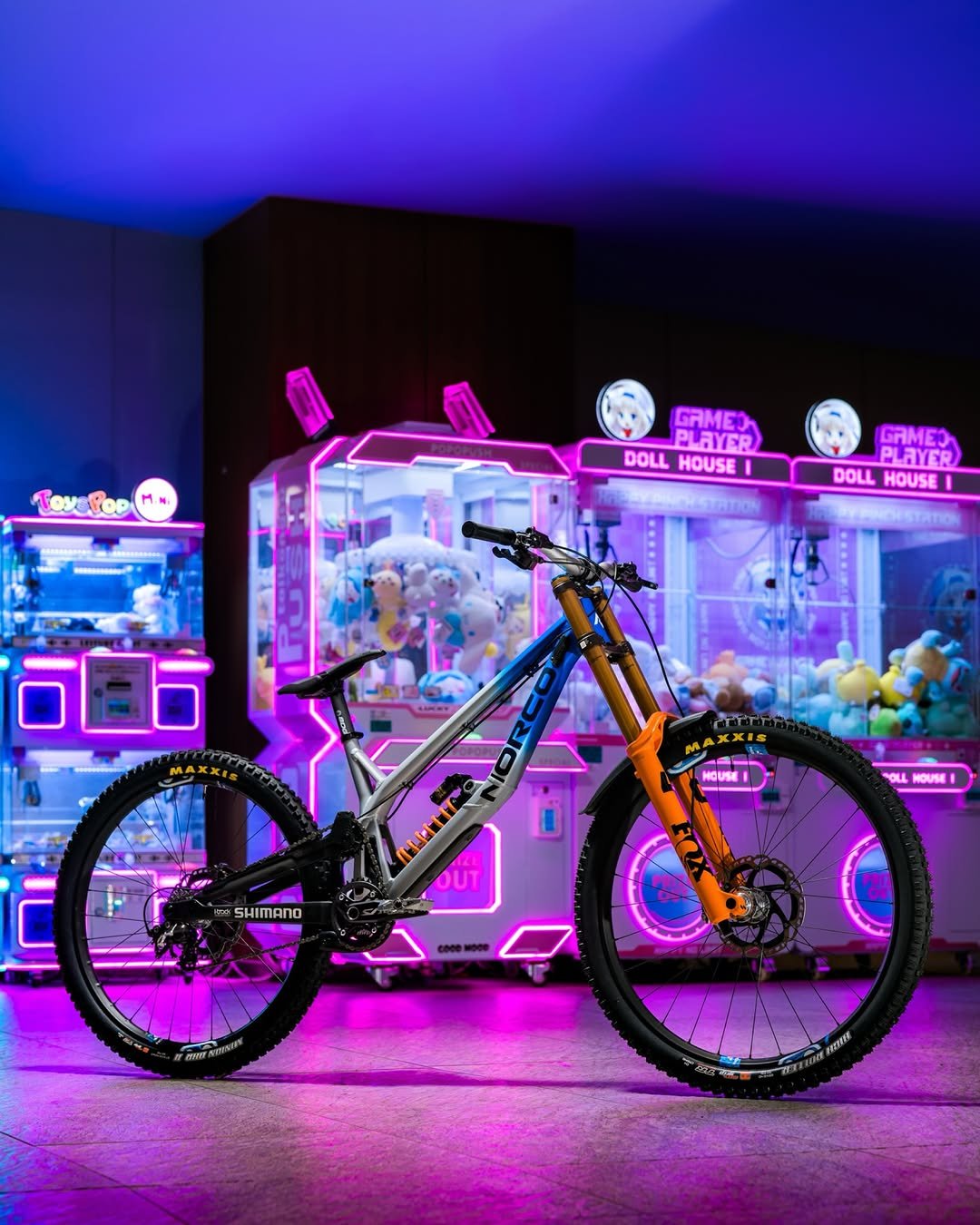 Photo shared by Norco adidas Race Division on April 28, 2026 tagging @norcobicycles, @pocsports, @adidasfiveten, @shimanomtb, and @ridefoxbike. May be an image of bicycle, scooter and text that says 'Toys ToxePoo GAMEO PLAYER DOLL HOUSE GAMEI PLAYER DOLL HOUSE DOLLHOUSE I HOUSE! OLL NOUSE SHIMANO PWATES 2WW'.