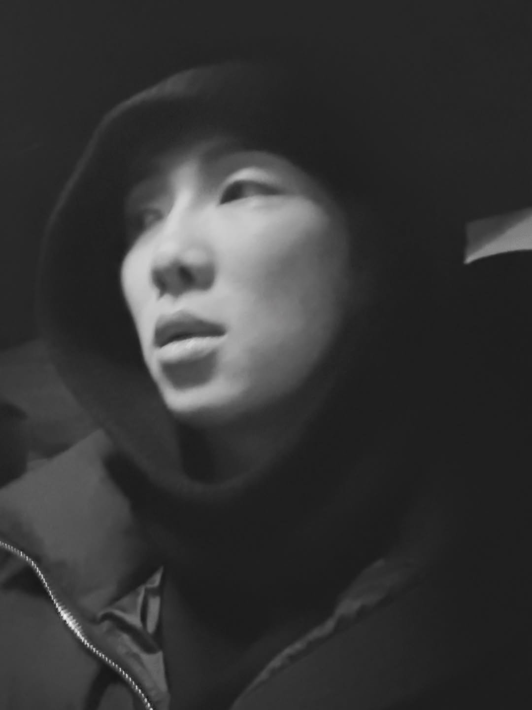 Photo by RM on February 08, 2026. May be a black-and-white image of one or more people, duffle coat, turtleneck, cloak, face mask, headscarf, parka and text.
