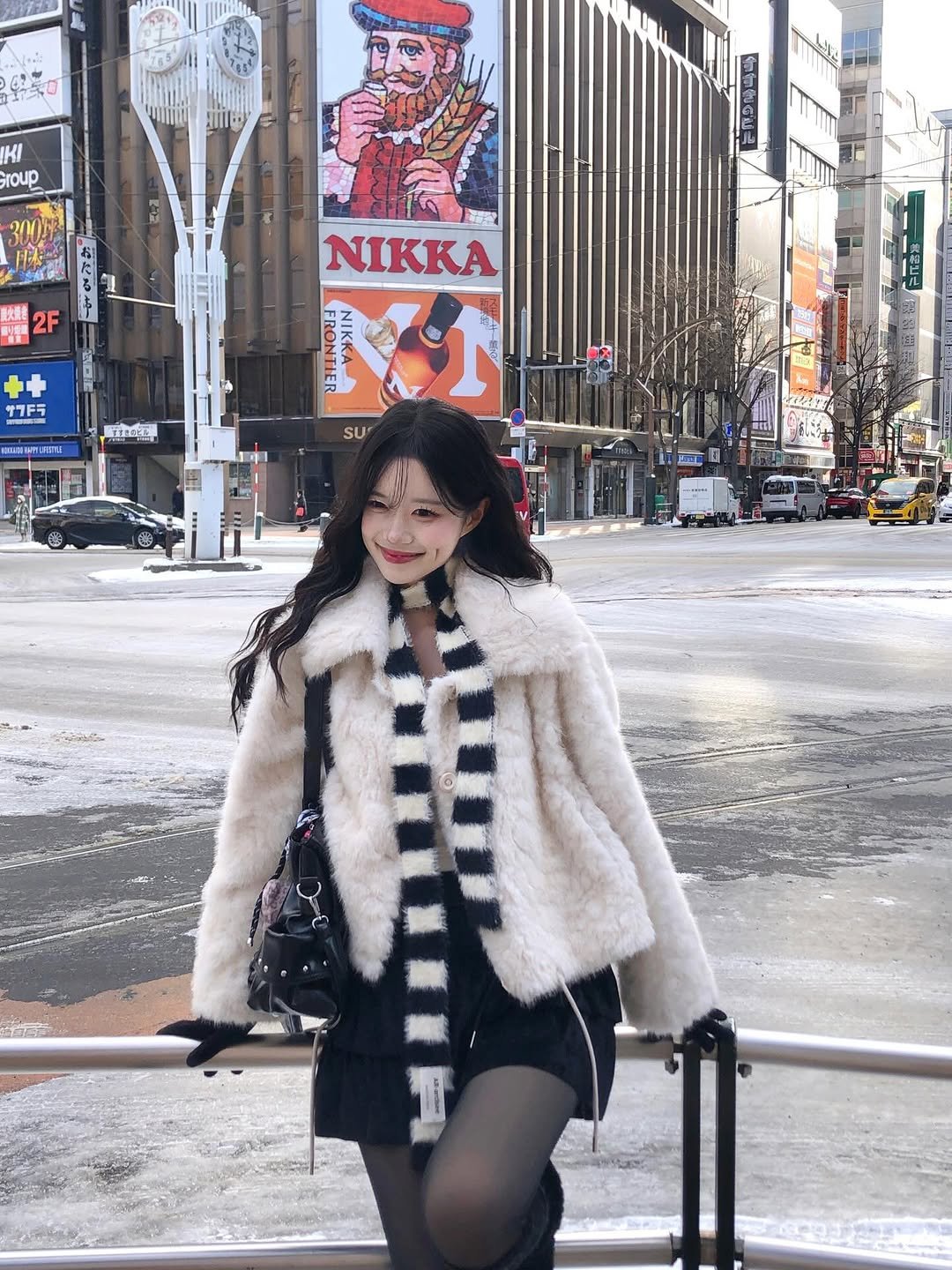 Photo shared by 노정화 on December 09, 2025 tagging @dayroze_official. May be an image of duffle coat, overcoat, parka, Times Square and text.