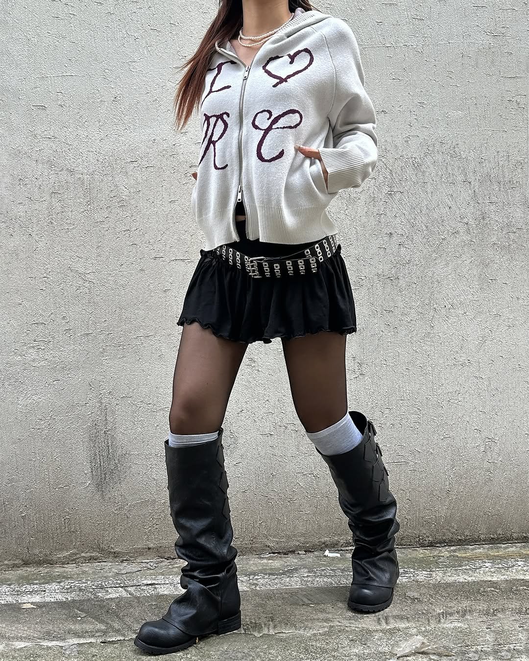 Photo by ROCKCAKE on November 03, 2025. May be an image of boots, miniskirt, fishnet stockings and text.