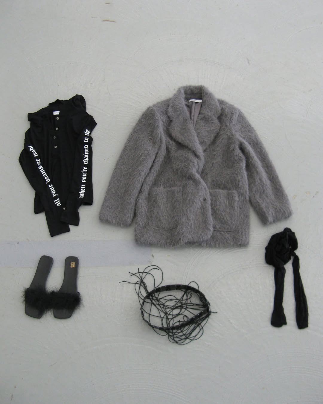 Photo by ROCKCAKE on December 10, 2025. May be an image of duffle coat, overcoat, parka, wool and text.