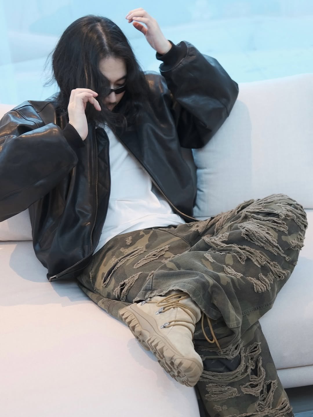 Photo shared by SEONGSU KIM on December 25, 2025 tagging @emostanceclub. May be an image of duffle coat, goosedown coat, flight jacket, military uniform, parka, sweatpants and text.