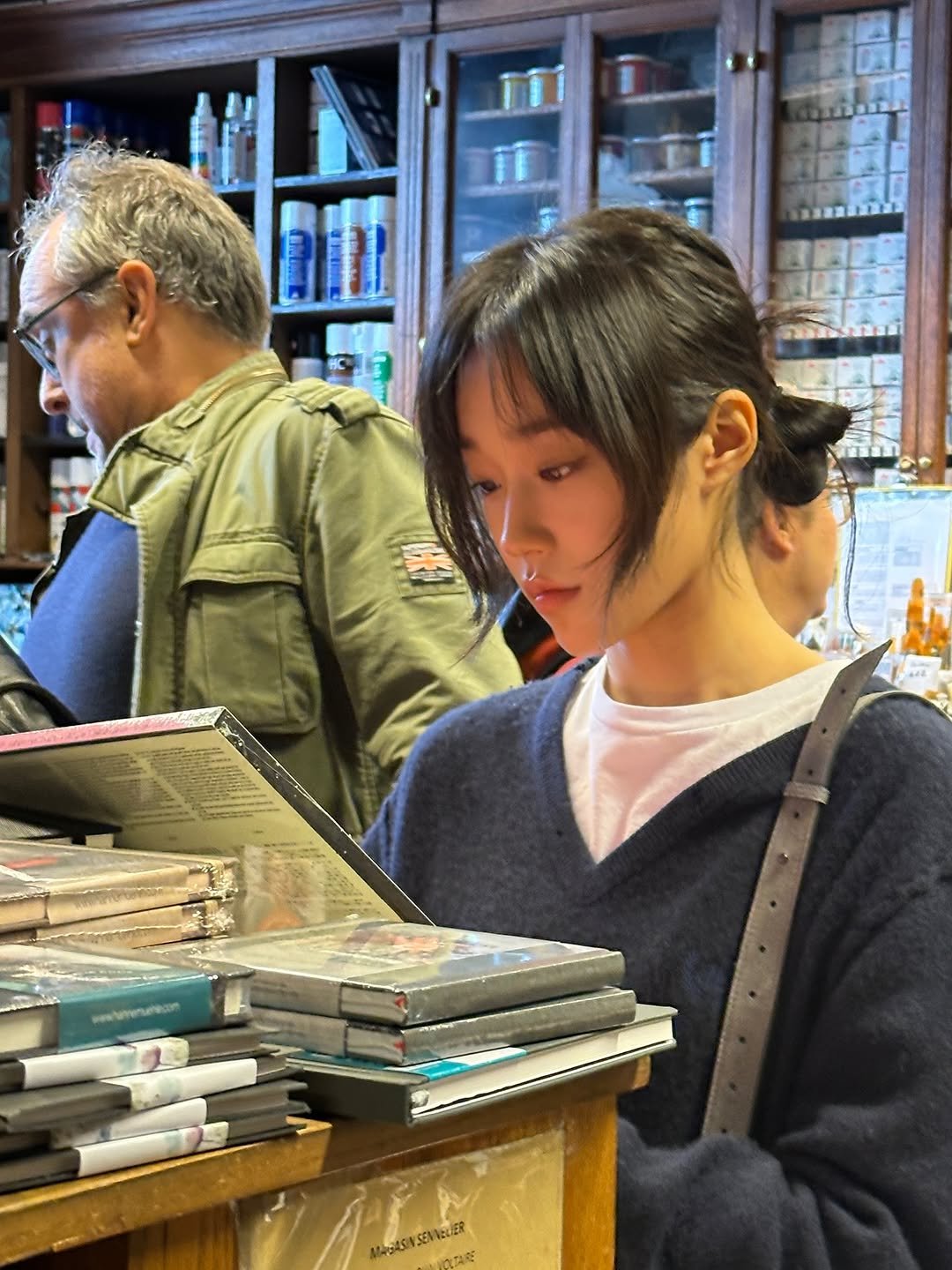 Photo shared by 노윤서 on November 18, 2025 tagging @balenciaga. May be an image of one or more people, book, newsstand and text.