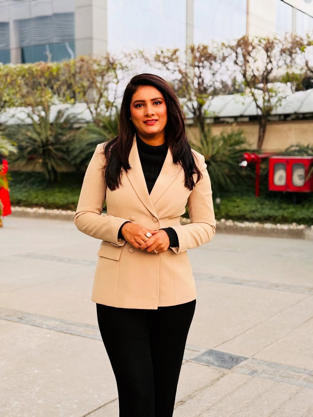 Photo by Romita Tiwari on February 22, 2026. May be an image of one or more people, people smiling, people standing, turtleneck, jacket, suit, blazer and text.