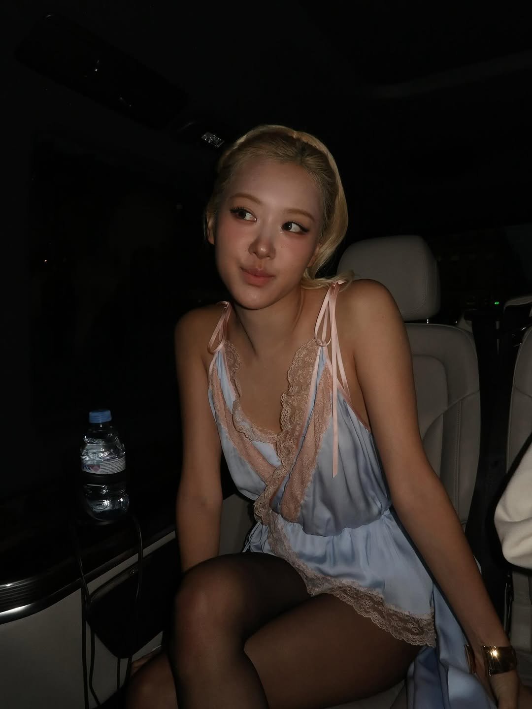 Photo by ROSÉ on September 29, 2025. May be an image of one or more people, hair, slip, dress, fishnet stockings, night and text.