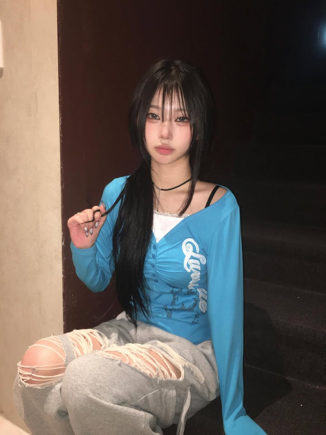 Photo shared by 예령 on April 20, 2026 tagging @luvistrue_official. May be an image of one or more people, hair, makeup, people smoking, cigarette, sweatshirt and text.