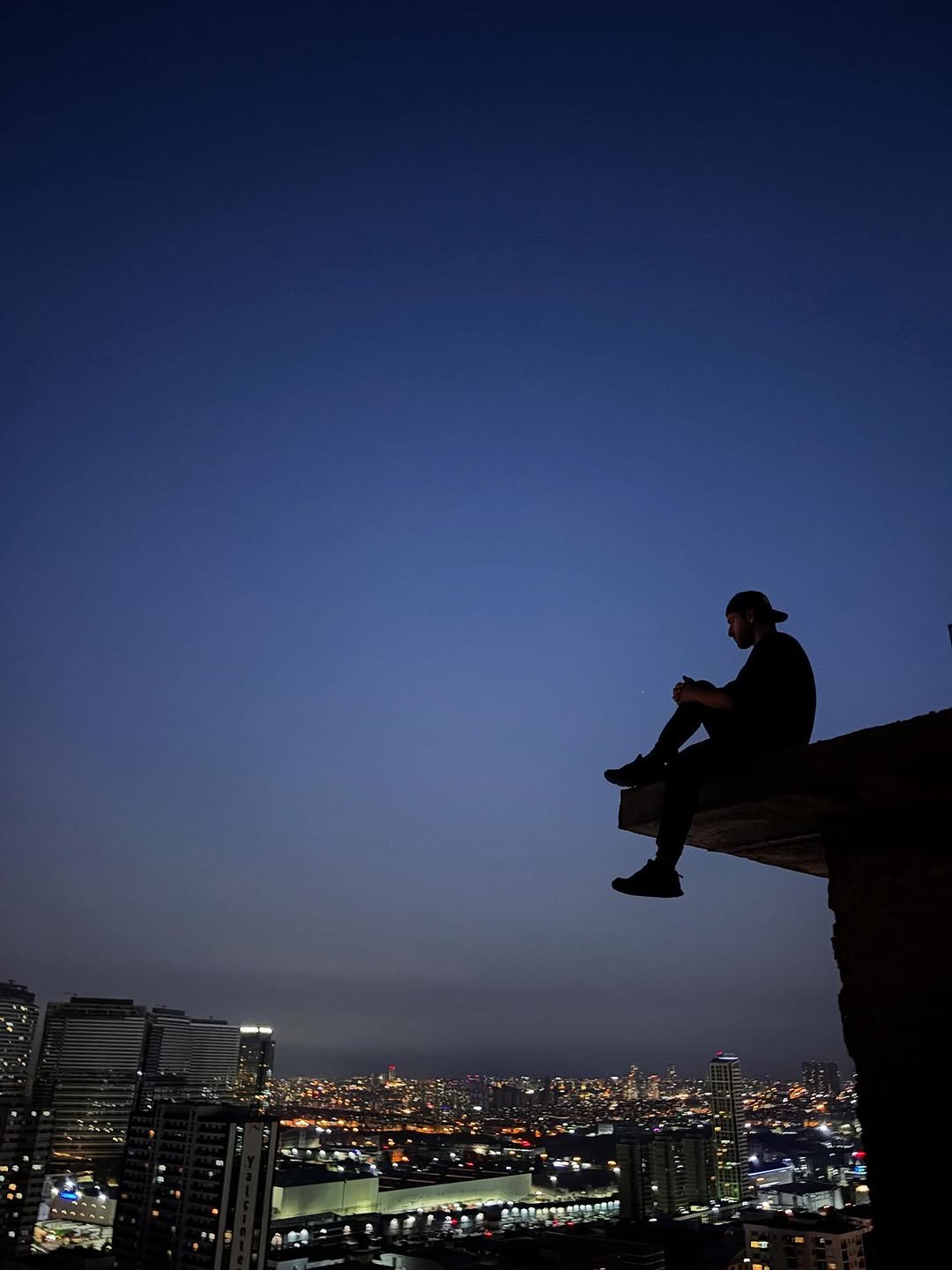 Photo by Mustafa kurt on August 22, 2025. May be an image of 1 person, twilight, night, sky, buildings and text.