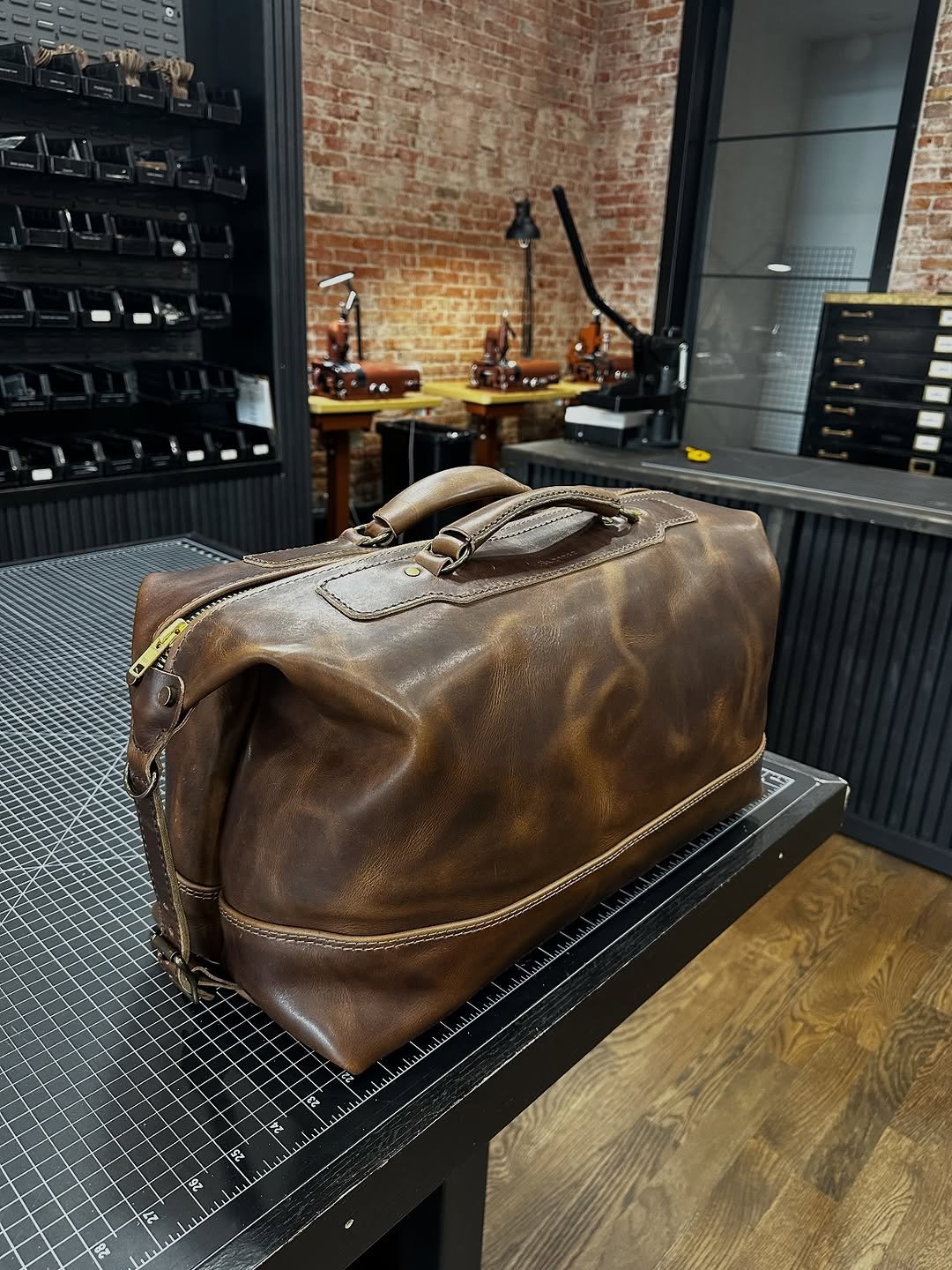 Photo shared by Ryan Blaney on November 15, 2025 tagging @rangeleather. May be an image of saddle-stitched leather, tool bag, leather, briefcase, luggage and text.