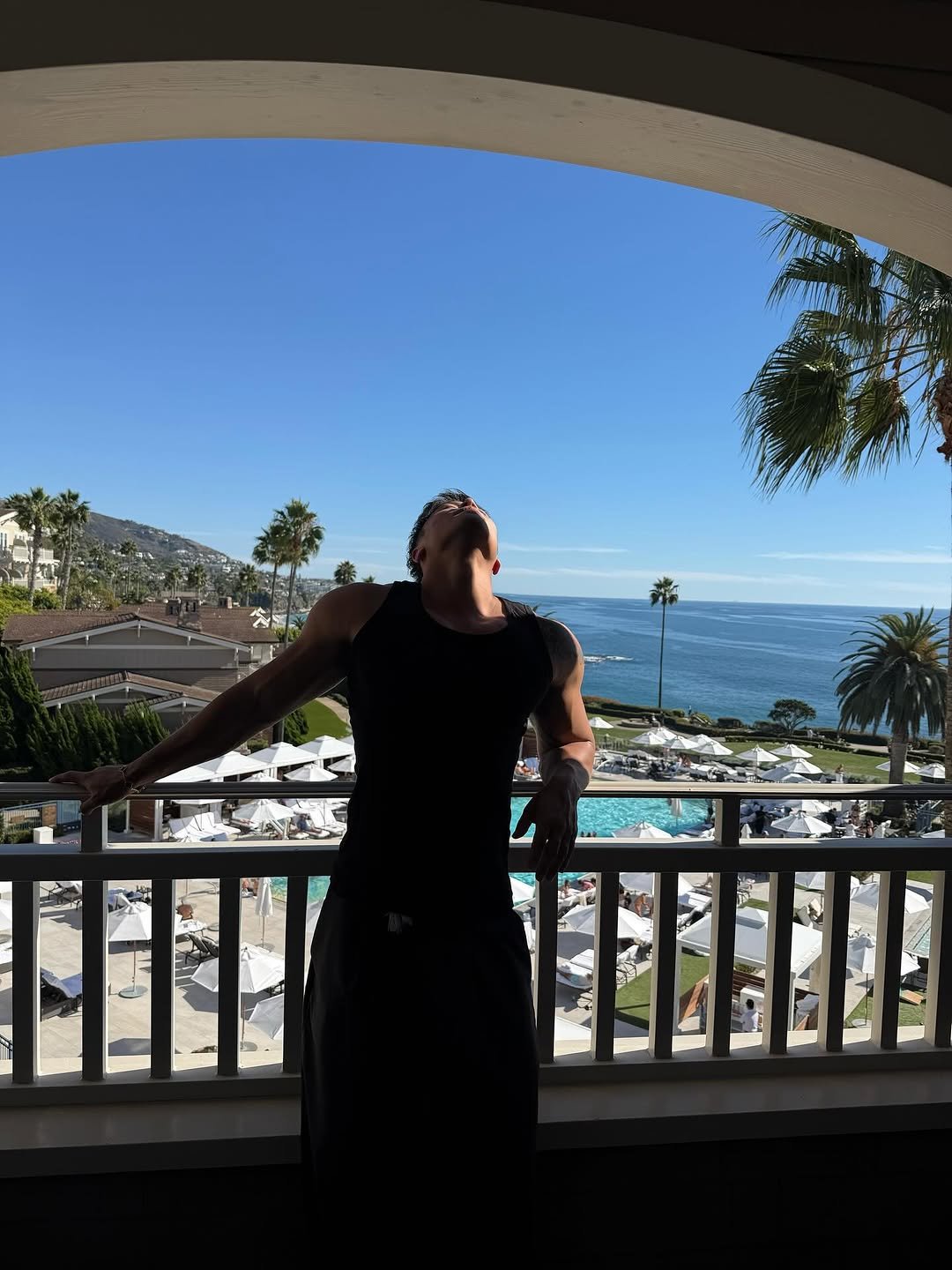 Photo by Ryan Ding on October 19, 2025. May be an image of standing, ocean, palm trees and text.