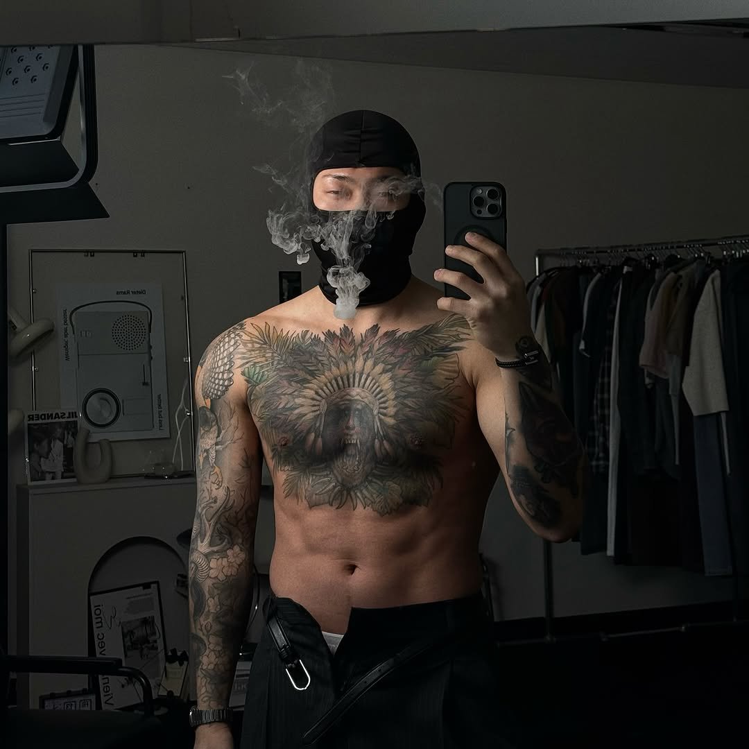 Photo shared by 돌쇠 on April 01, 2025 tagging @look.at.stone. May be an image of 1 person, beard, tattoo, kilt, gas mask, sweatpants, face mask and text.