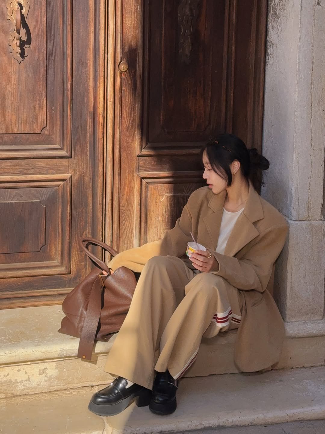 Photo by 이솔이 ✨ on November 27, 2025. May be an image of duffle coat, overcoat, door and text.