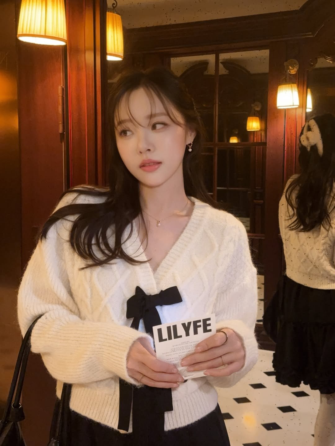 Photo by 이솔이 ✨ on December 12, 2025. May be an image of one or more people, hair, bolo tie and top.