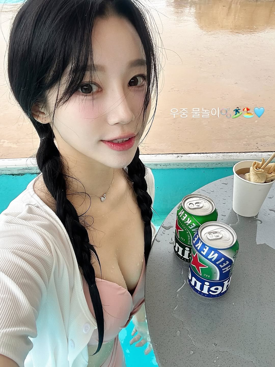 Photo by 승지 on October 08, 2025. May be an image of 1 person, hair, beer, bra, pool and text.