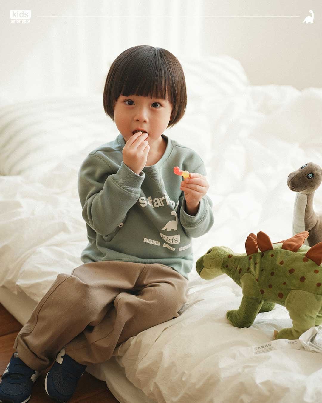 Photo shared by safarispotkids on November 17, 2025 tagging @safarispot. May be an image of child, bangs, duffle coat, toy and text.