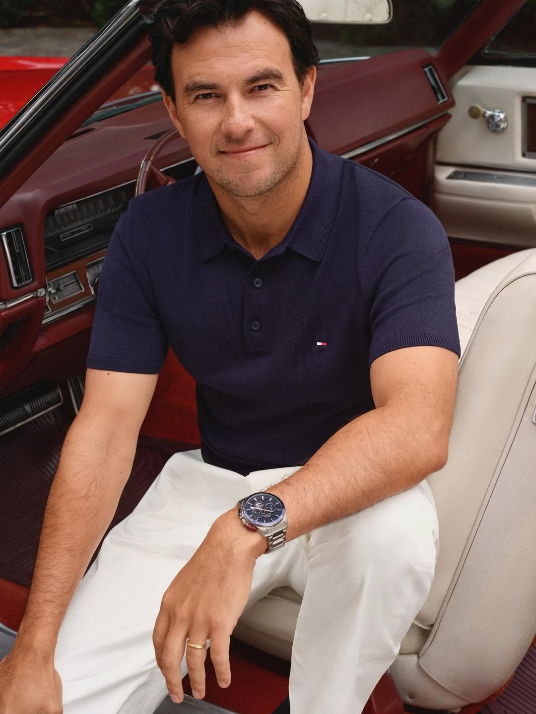 Photo shared by Tommy Hilfiger on December 10, 2025 tagging @schecoperez. May be an image of one or more people, wrist watch and text.