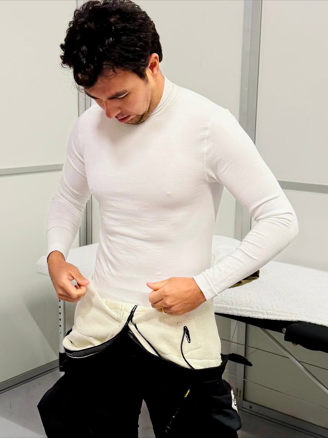 Photo by Checo Pérez on November 14, 2025. May be an image of pants, sweatsuit, sweatpants, turtleneck and text.