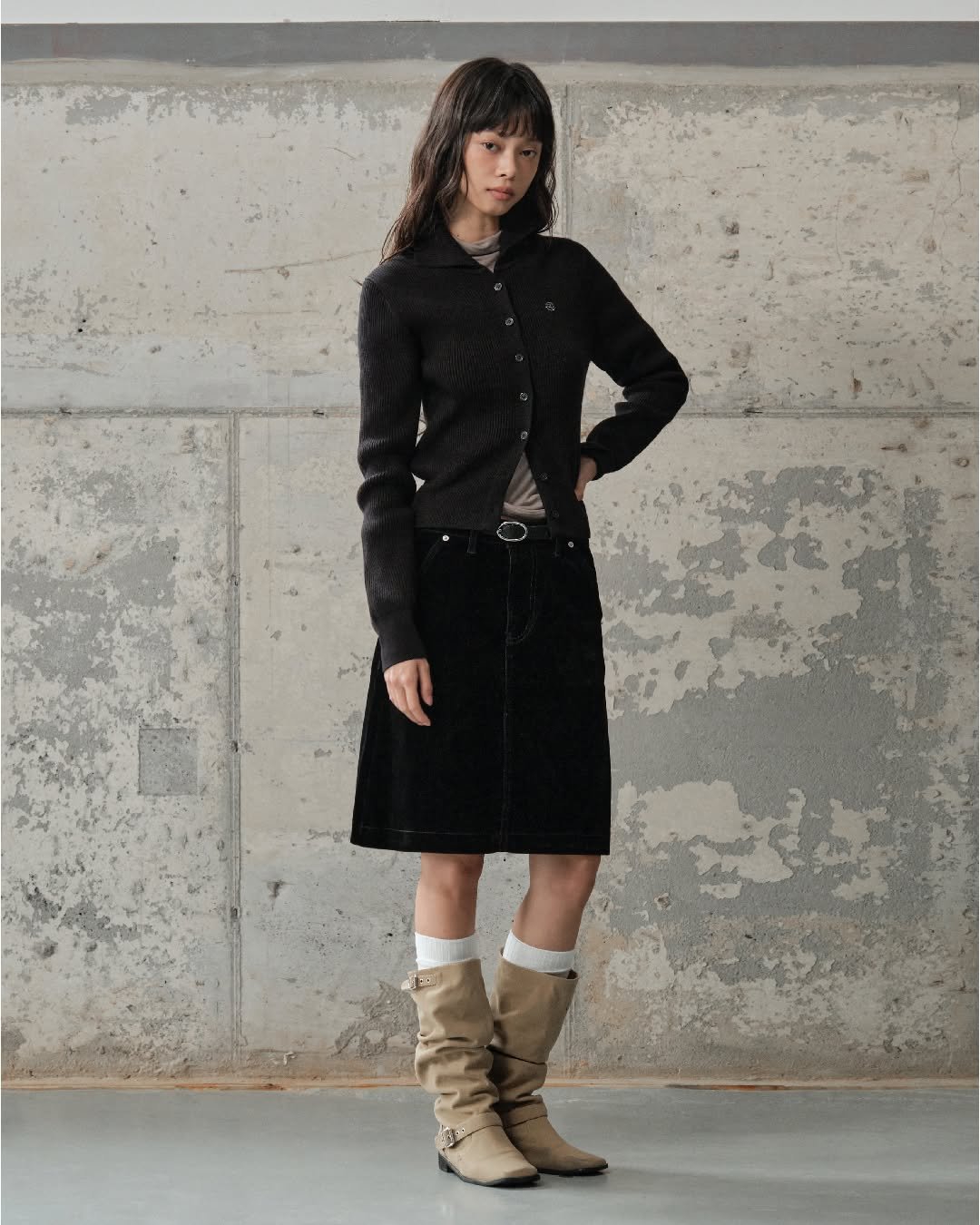 Photo by 세컨모놀로그 on September 17, 2025. May be an image of 1 person, outerwear, kilt, miniskirt, boots, wool and text.