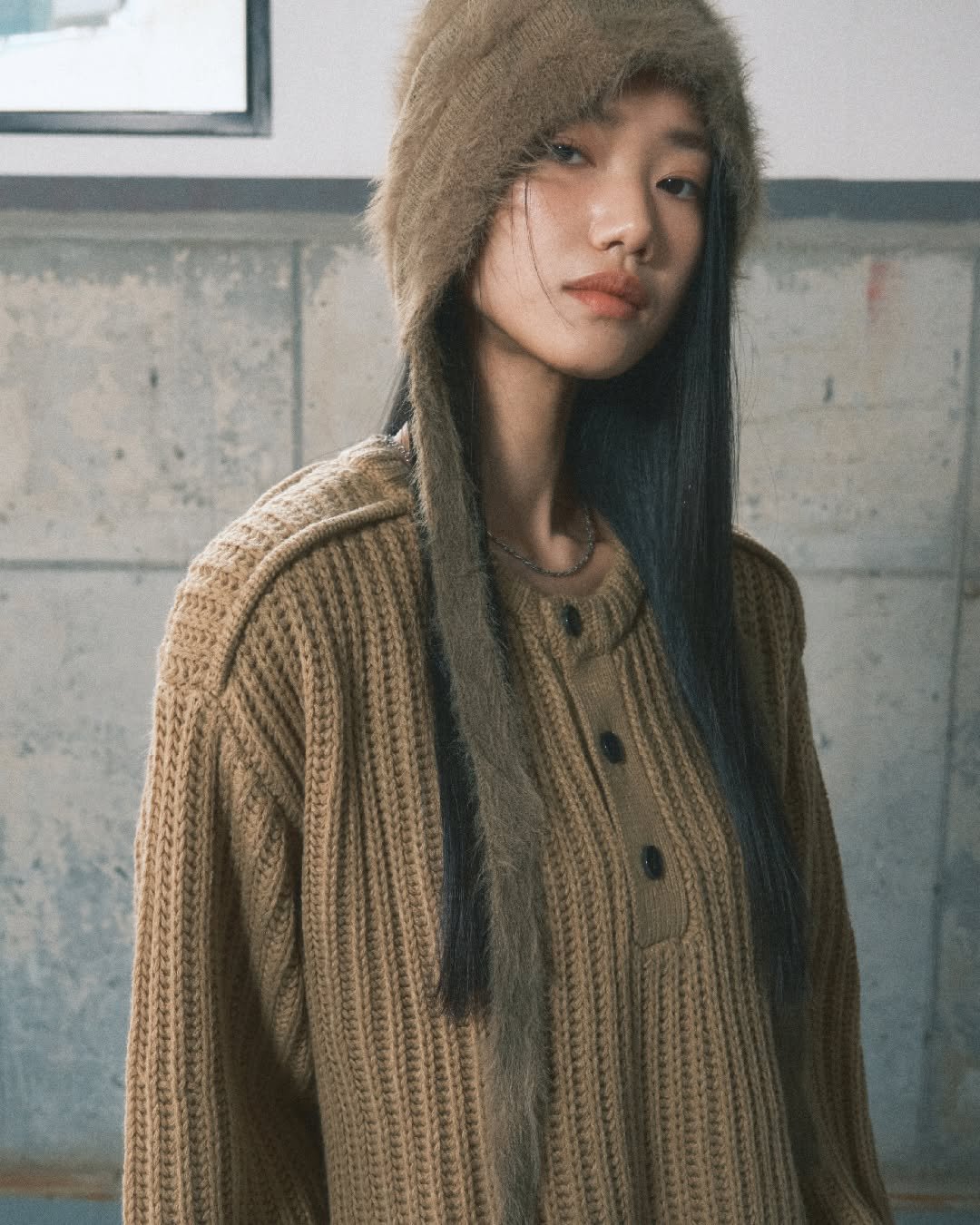 Photo by 세컨모놀로그 on September 12, 2025. May be an image of 1 person, hat, turtleneck, cardigan, sweater, wool, knit, outerwear and text.
