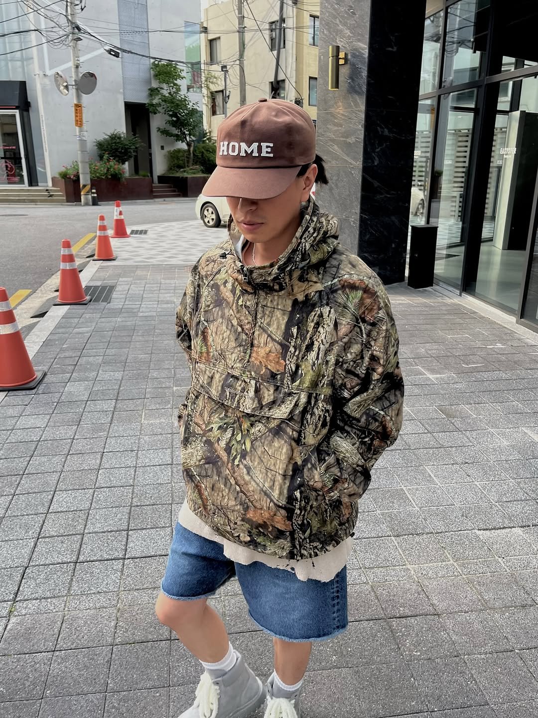 Photo shared by 심시티🦡 on September 23, 2025 tagging @thisisneverthat. May be an image of 1 person, hat, military uniform, jacket, shorts, parka and text.