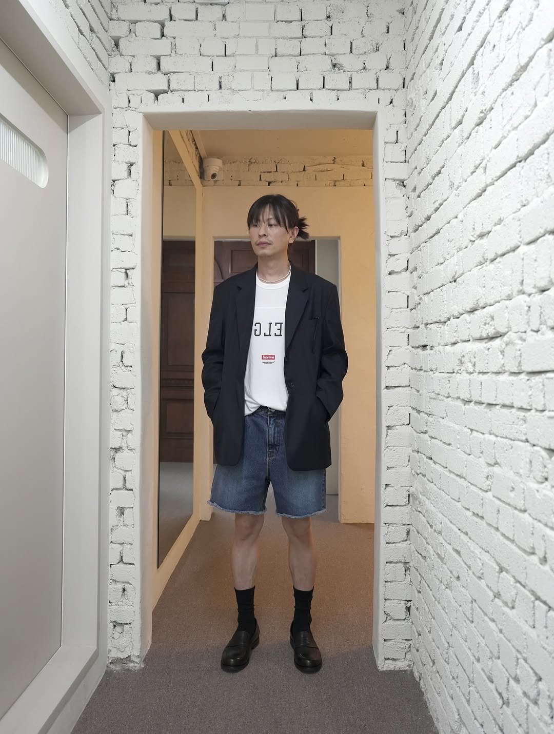 Photo shared by 심시티🦡 on September 17, 2025 tagging @josepht_official. May be an image of duffle coat, shorts and text.