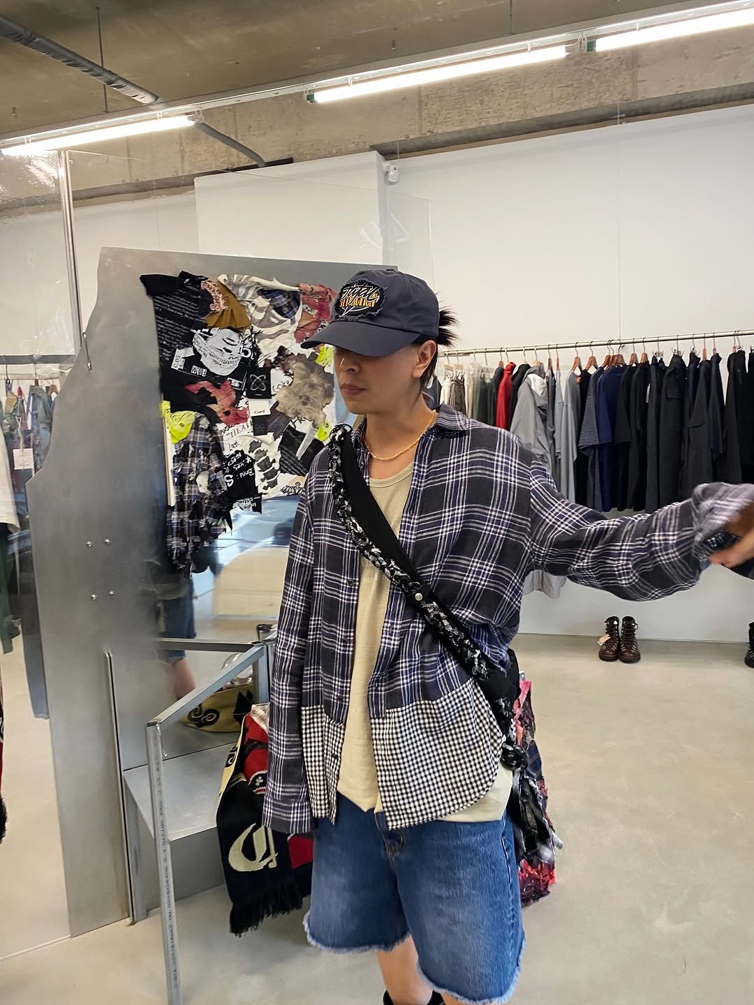 Photo shared by 심시티🦡 on July 19, 2025 tagging @thecord_official. May be an image of 1 person, clothes hanger, outerwear, hat shop and text.