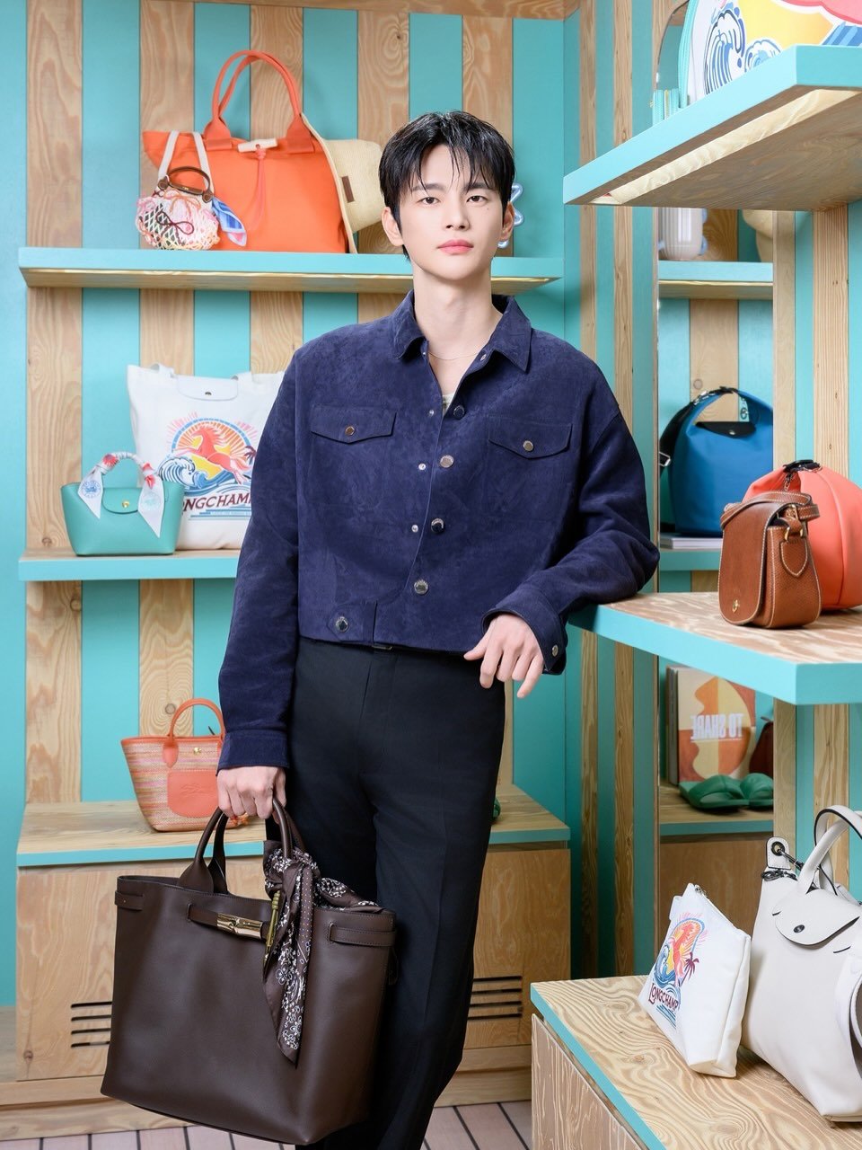 Photo shared by 서인국 Seo In Guk on April 09, 2026 tagging @longchamp. May be an image of duffle coat, purse, briefcase and text.