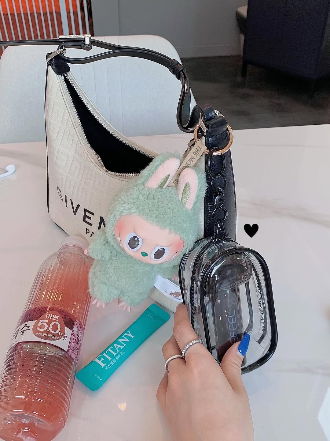 Photo by 서진♡︎ on July 06, 2025. May be an image of purse, hand cream, perfume, water bottle, bottle and text.