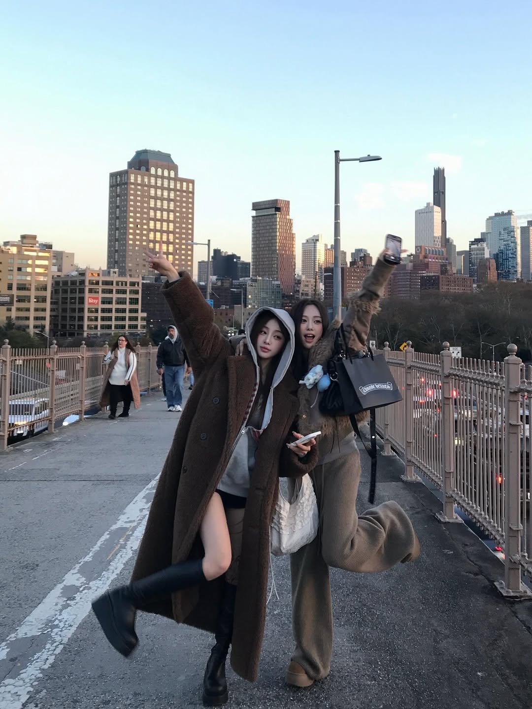 Photo shared by 김선우 on December 17, 2025 tagging @all_zero._.k. May be an image of overcoat, the Brooklyn Bridge and text.